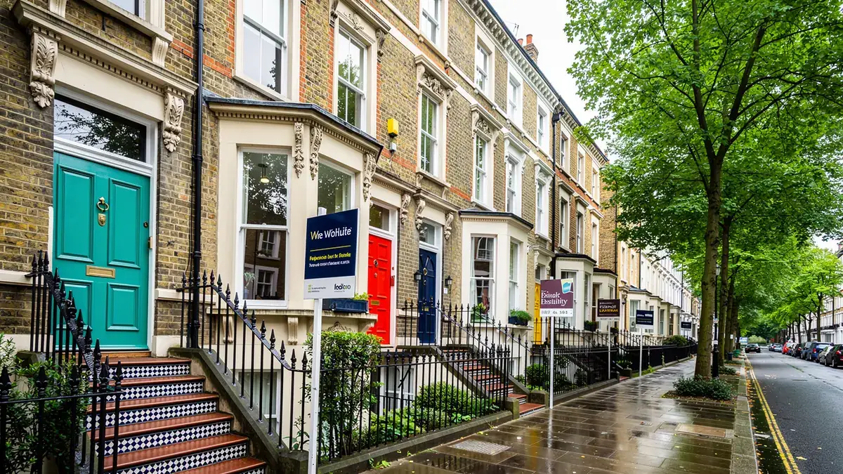 London Victorian terraced houses with estate agent for sale boards
